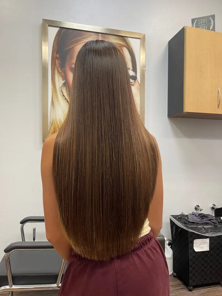 Finished long, straight, glossy brunette hair, back view in the suite